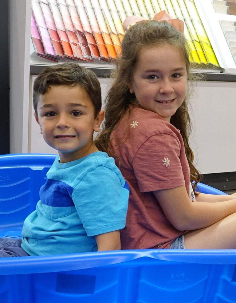 Kids sitting in a swimming pool